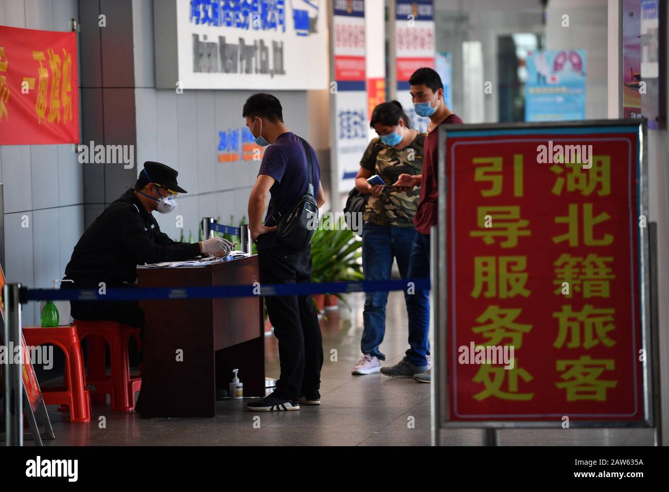 (200207) -- HAIKOU, Feb. 7, 2020 (Xinhua) -- A staff member from Haikou of south China's Hainan Province records information of passengers in Xuwen County of Zhanjiang City, south China's Guangdong Province, Feb. 6, 2020. Qiongzhou Strait is a major passage into and out of Hainan Island. Since the start of the prevention and control of pneumonia caused by the novel coronavirus, Hainan and Guangdong have both moved the prevention and control threshold forward. Hainan has sent more than 160 joint anti-epidemic personnel from multiple departments to Zhanjiang of Guangdong Province, and set up fou Stock Photo