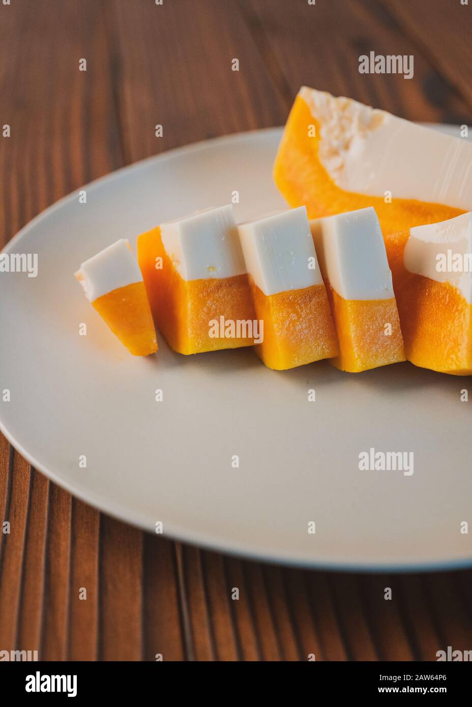 Delicious papaya milk jelly, sliced on a plate. Home made dessert Stock