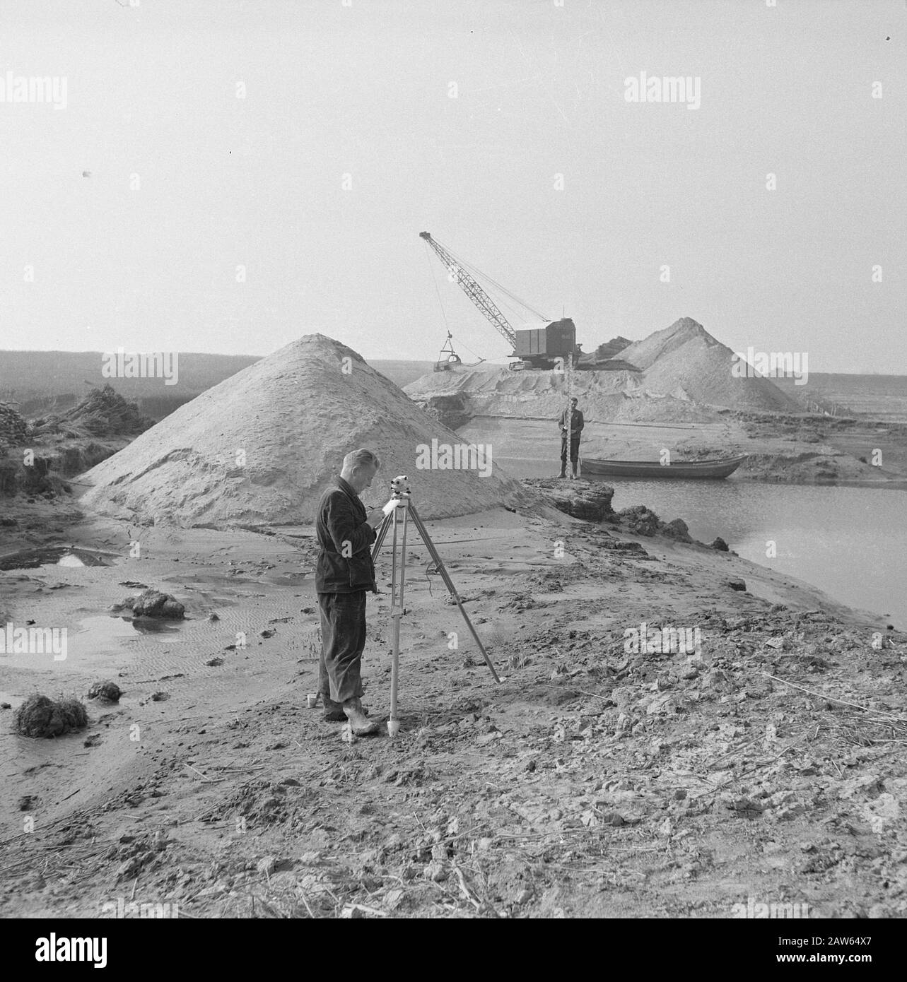 men, measuring instruments, sand hills, dig and Date undated Keywords
