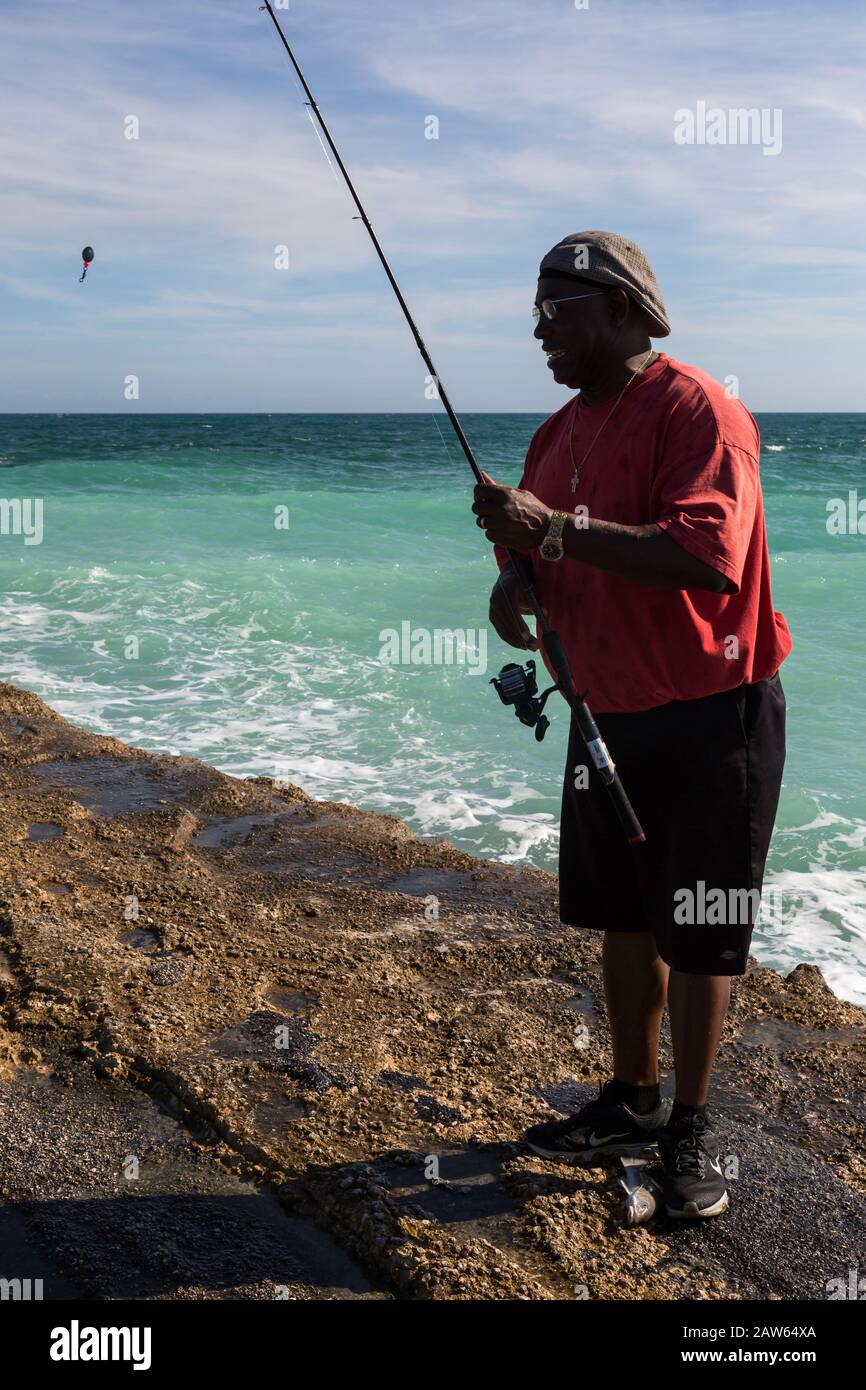 A Treasure Coast fisherman on the jetty at the Fort Pierce Inlet checks