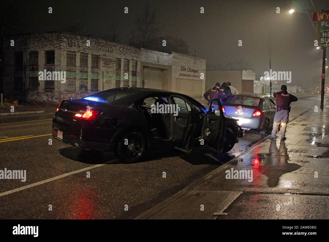 Detroit police Special Ops officers stop a vehicle and speak to the