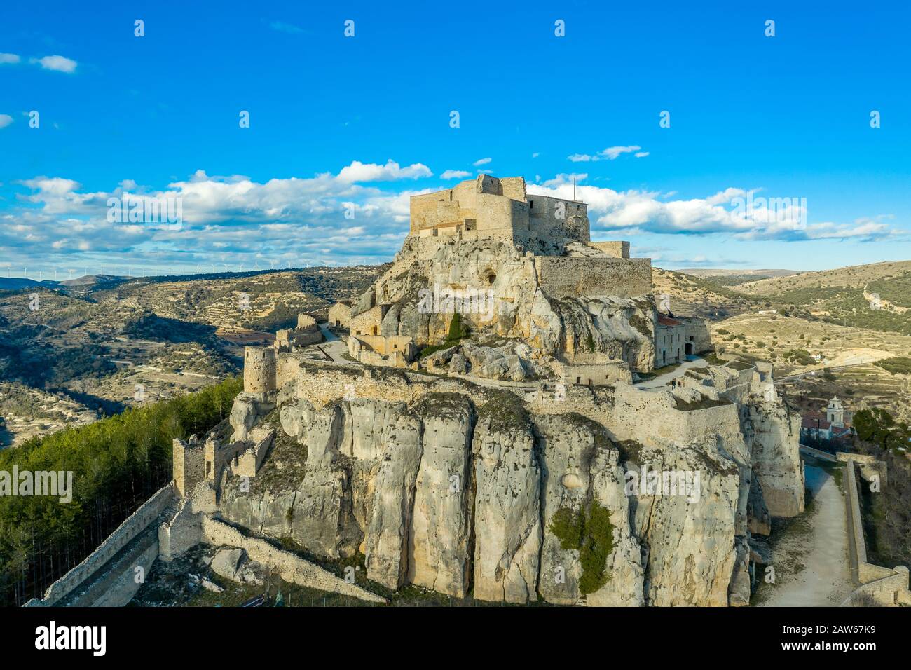 Aerial sunset view of Morella, medieval walled town with semi circular towers and gate houses crowed by a fortress on the rock in Spain Stock Photo