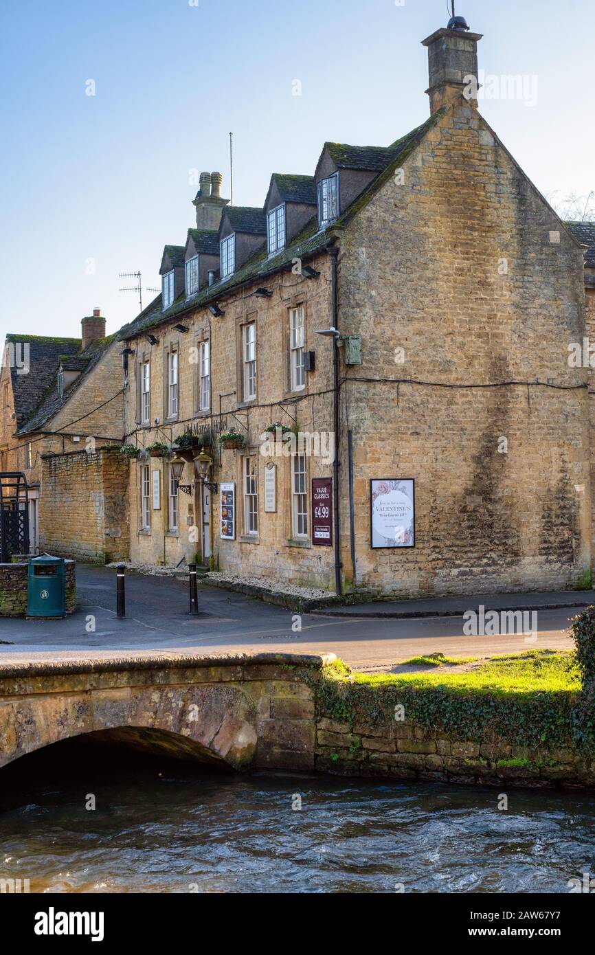 Old manse hotel in the afternoon winter sunlight. Bourton on the Water, Cotswolds