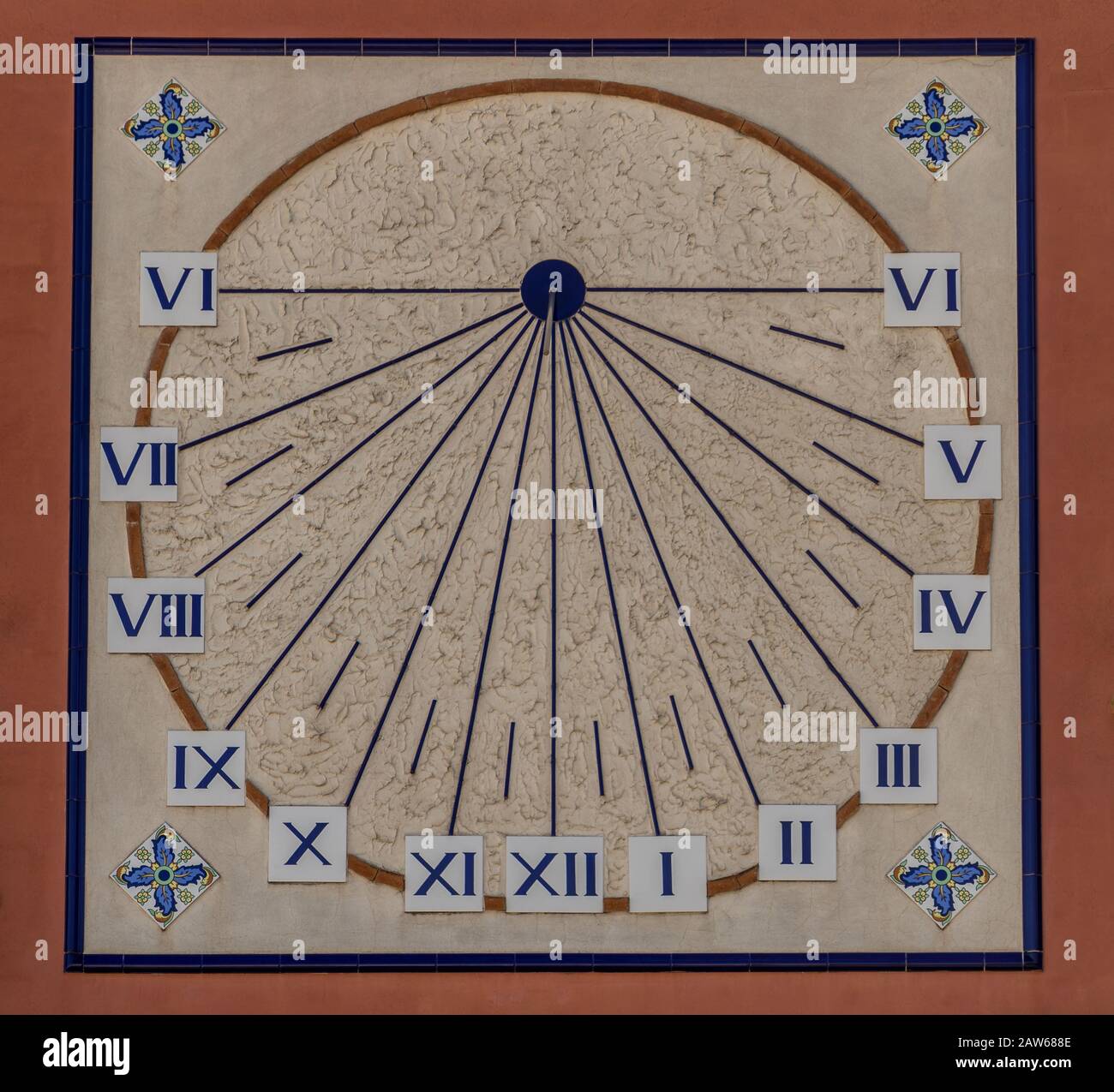 Blue and orange sun dial on a house wall in Onda Spain Stock Photo