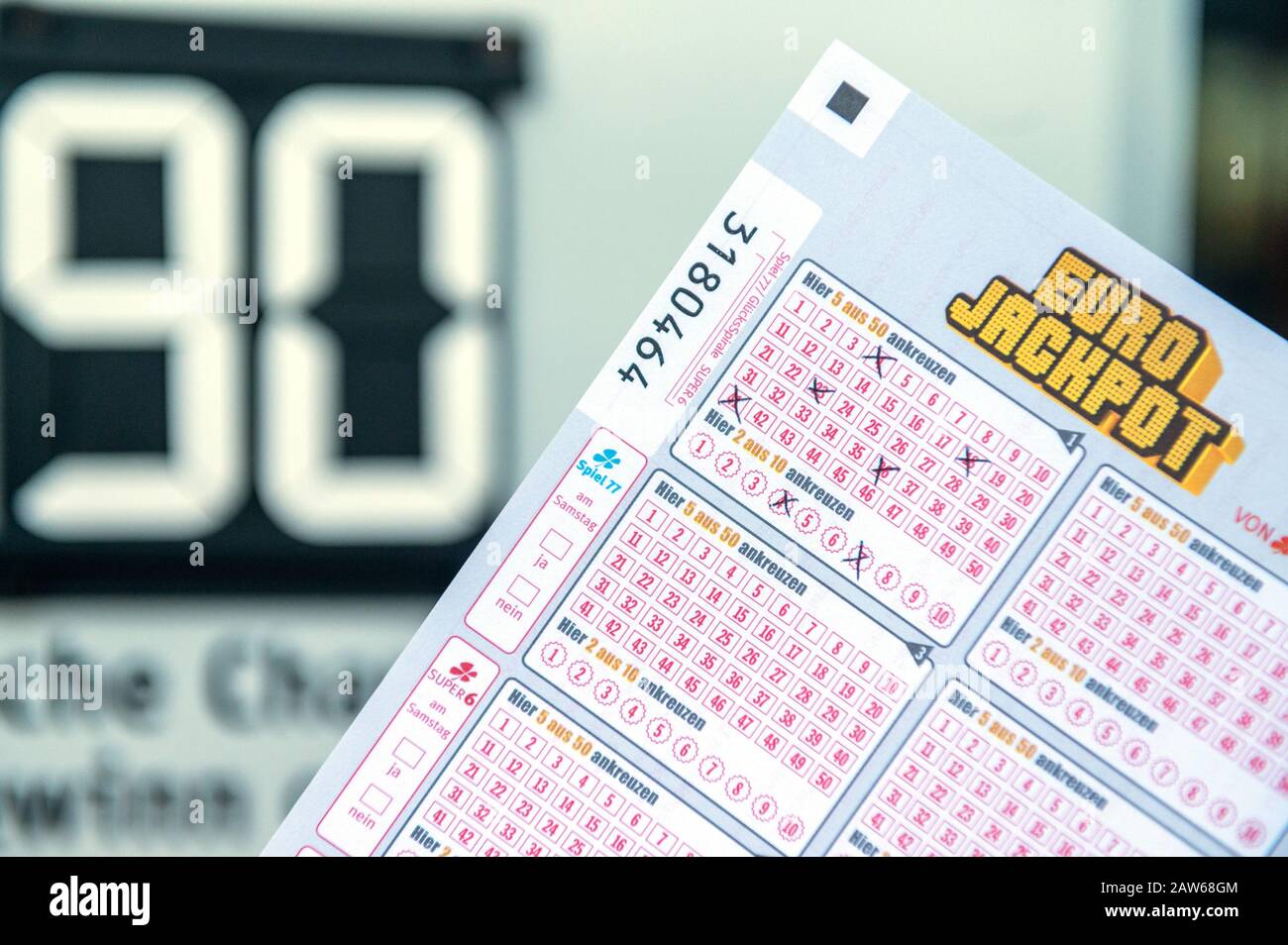 Freiburg, Germany. 06th Feb, 2020. A Eurojackpot ticket is displayed in  front of a lottery ticket office in front of a board indicating that the  winning amount of 90 million in the