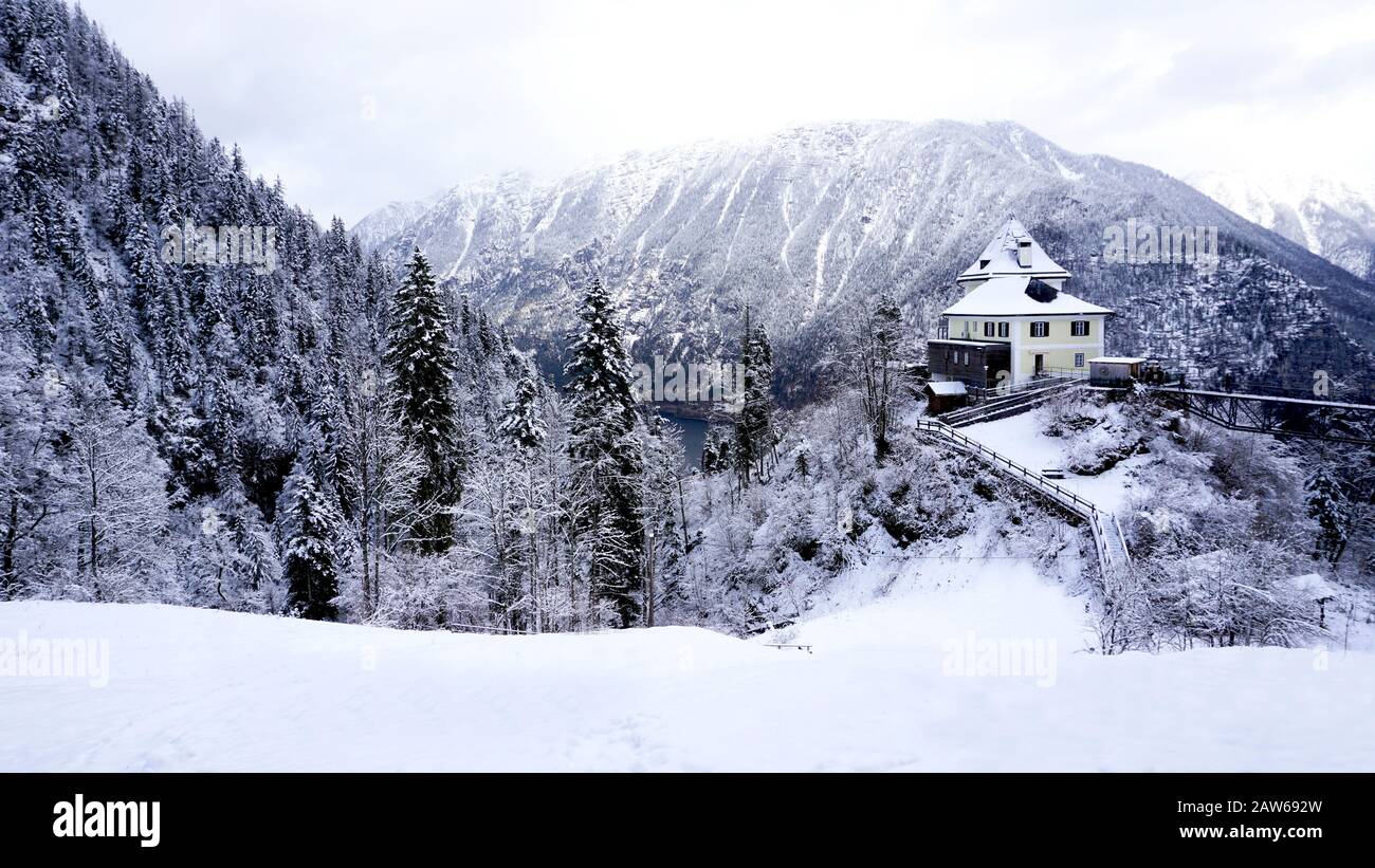 Scenery of Hallstatt Winter snow mountain landscape valley and lake through the forest in upland valley leads to the old salt mine of Hallstatt, Austr Stock Photo