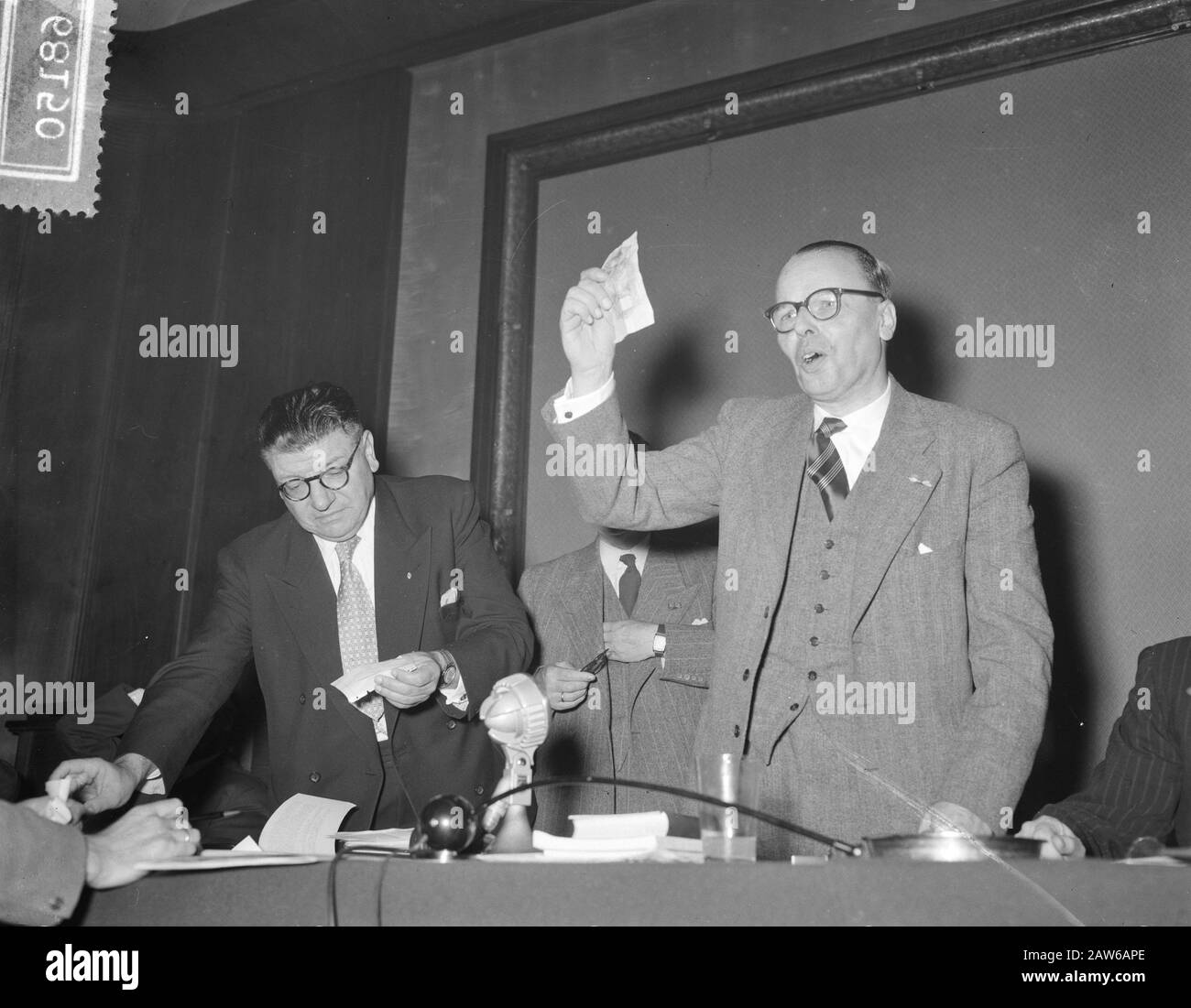 KNVB meeting Amsterdam Annotation: A peaceful general meeting of the KNVB was still noisy when a collection was held at the end of the emergency fund (ie to combat NBvB). . The president ir Hopster shows the first 100 f - who came into the hat collection. Beside him, the Secretary Mr. Brunt Date: October 30, 1954 Location: Amsterdam, Noord-Holland Keywords: sports, clubs, meetings, football Institution Name: KNVB Stock Photo