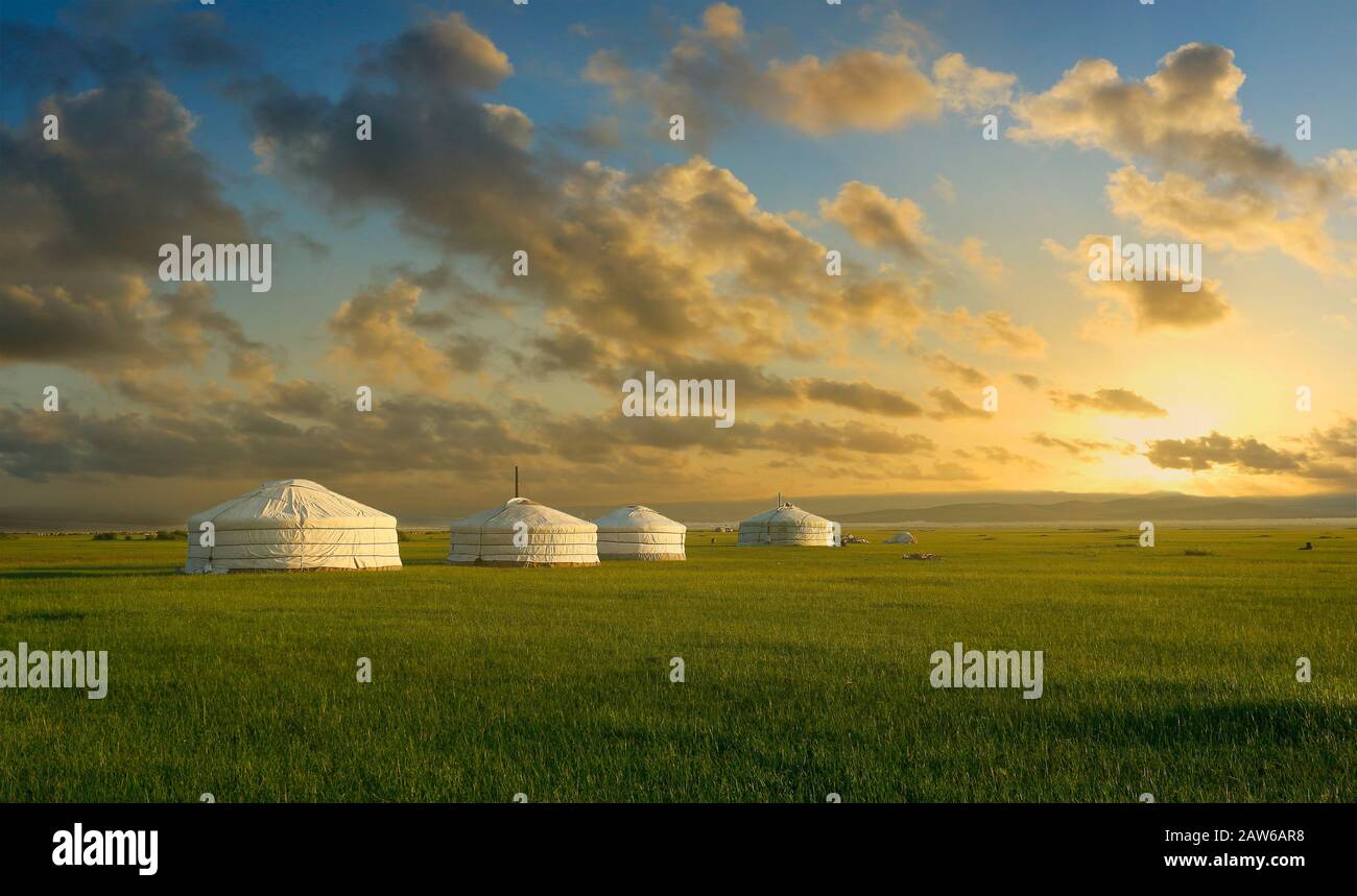 sunset on a nomad place with 4 yurts , in the grassland of Mongolia Stock Photo