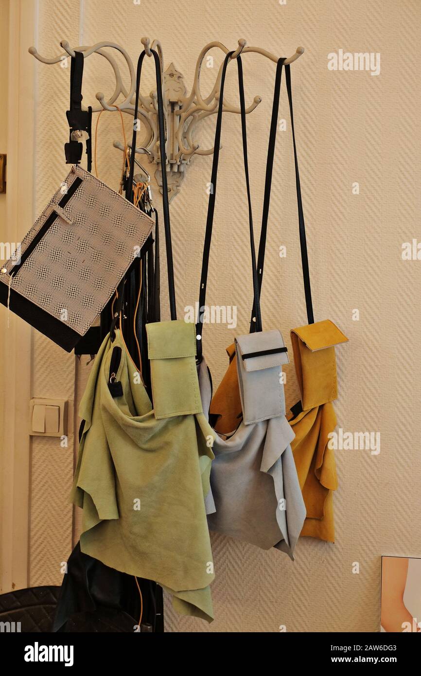 Purses and neck sacs hanging on display at Catherine Loirets leather design workshop Rue Amélie, Paris, France Stock Photo