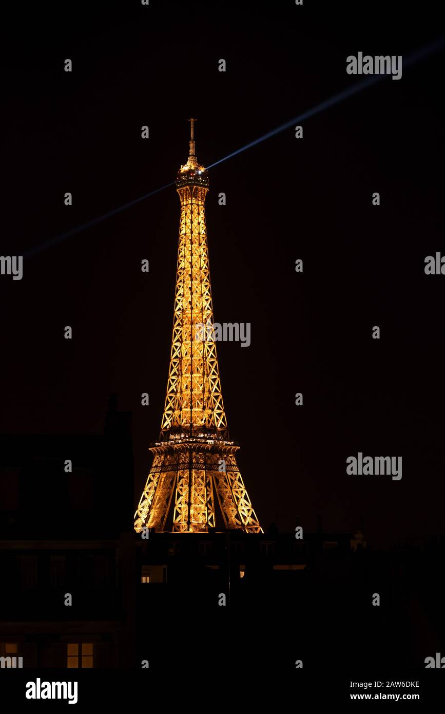 Beautiful and enigmatic, the Eiffel tower illuminated at night with ...