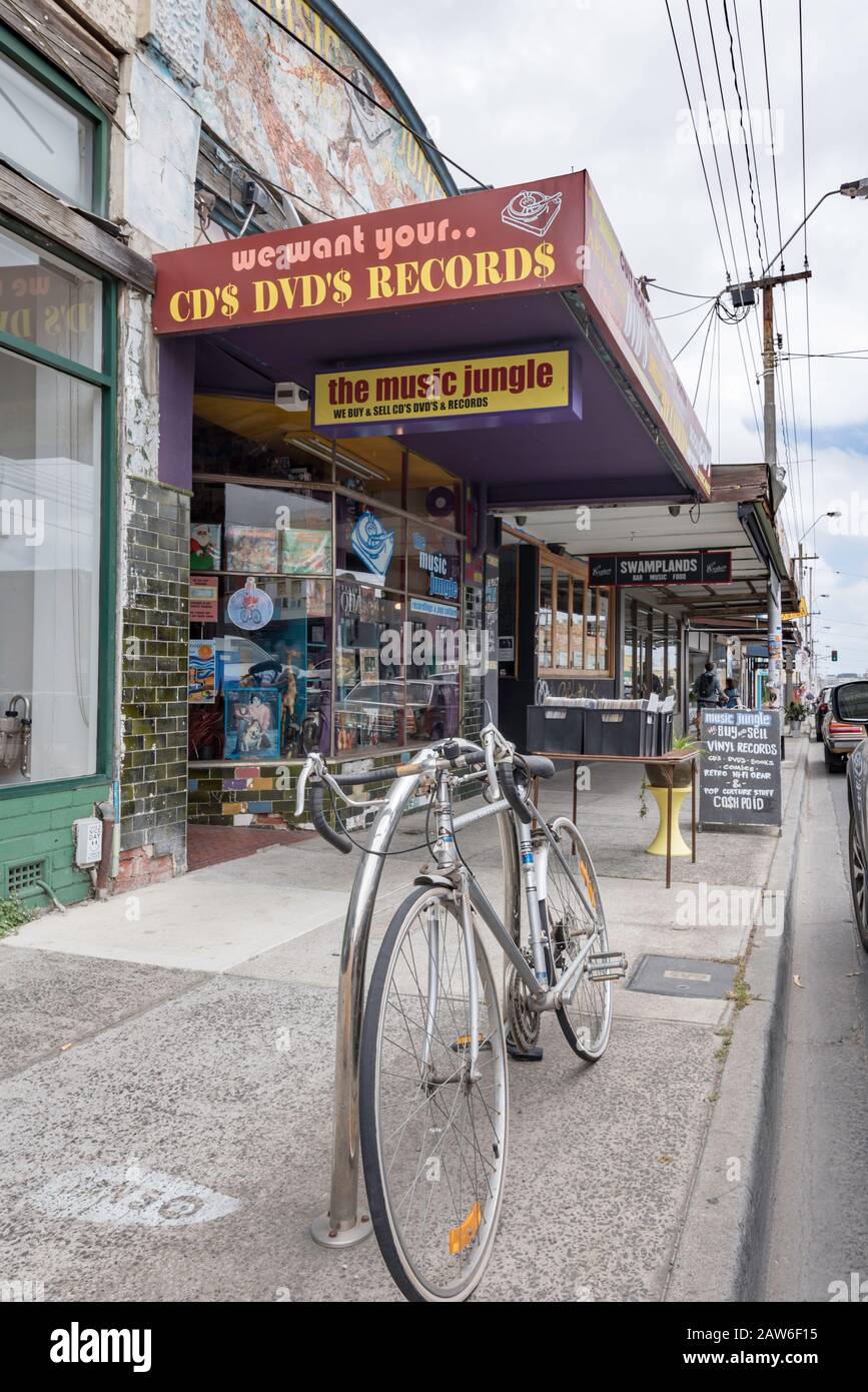 A bicycle with rams horns handlebars parked outside the Music Jungle record and DVD store in