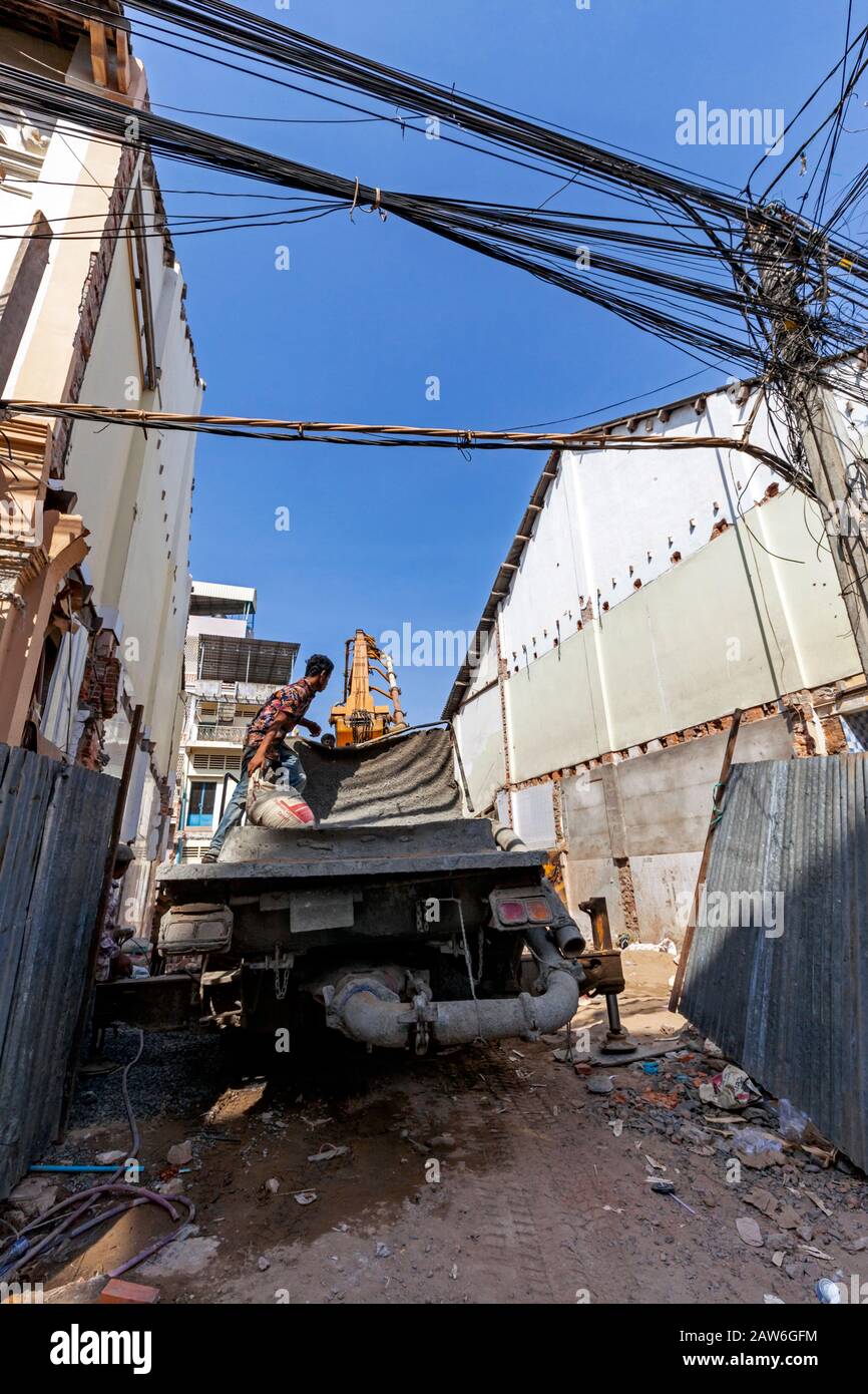 A small pile driver is set up on the construction site of a new building on a vacant lot in the city center of Kampong Cham, Cambodia. Stock Photo
