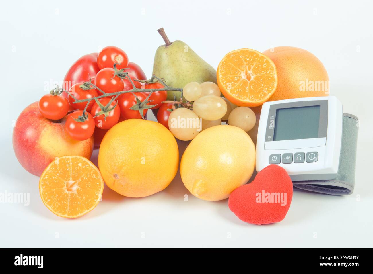 Vintage photo, Blood pressure monitor and fresh fruits with vegetables ...
