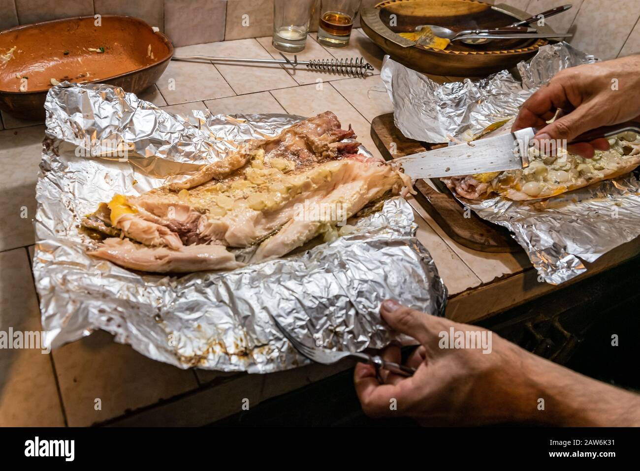 Homemade grilled dorado fish with vegetables wrapped in aluminum foil