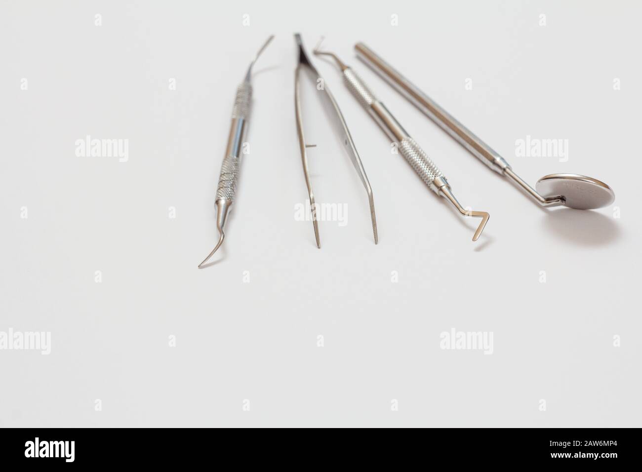 Set of composite filling instruments for dental treatment on white background. Medical tools concept. Close-up view. Shallow depth of field. Stock Photo