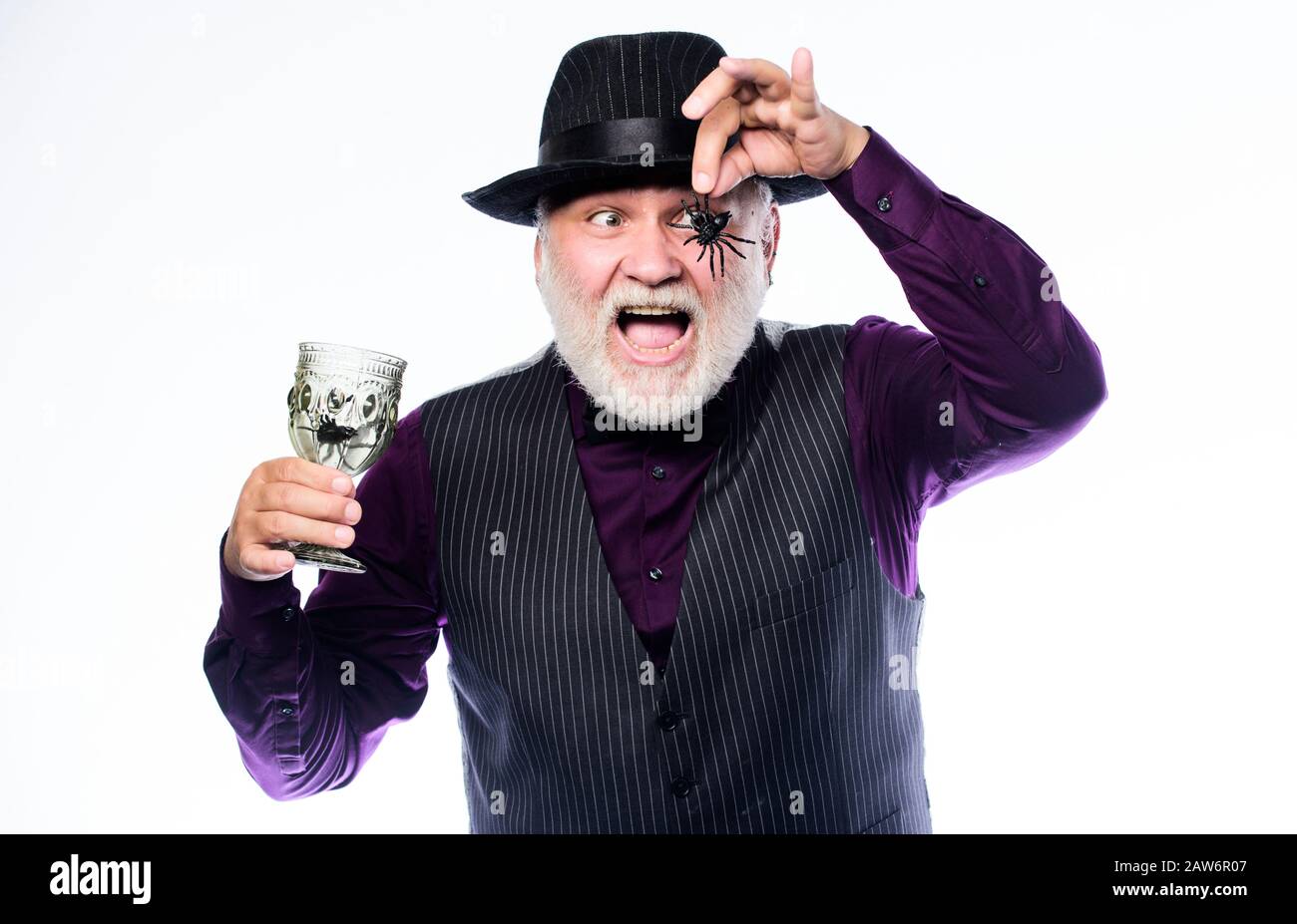 Halloween night. halloween holiday costume. barman make cocktail for halloween party. mature man magician in witch hat. happy halloween. evil wizard cooking magic potion with spider. Stock Photo
