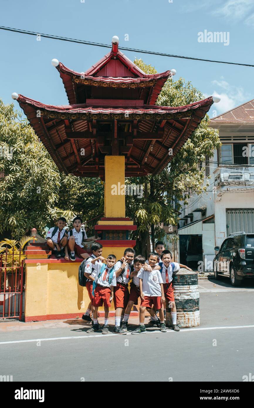 Manado, Indonesia - August 04 2015: Group of young students in uniform in street of Manado on North Sulawesi. Stock Photo