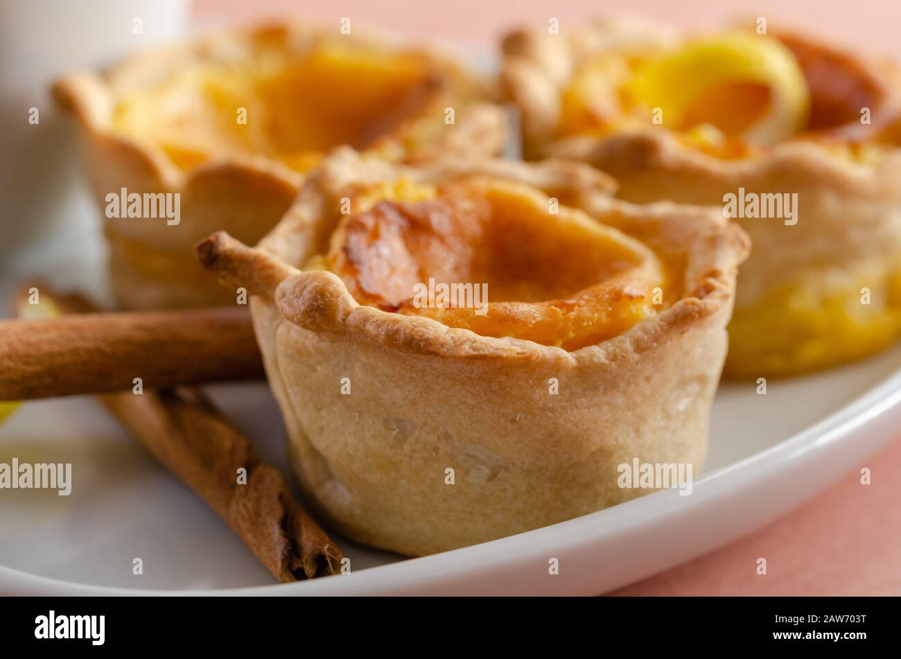 Portuguese egg tart pastry Pastel de nata and cup of coffee on the white plate Stock Photo