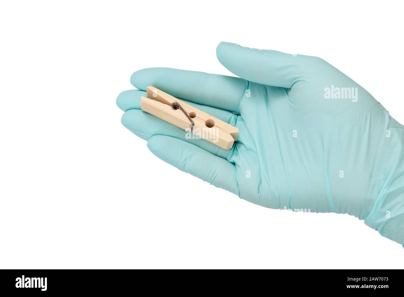 Woman hand in blue latex glove holding a wooden clothespin on a white isolated background. Stock Photo