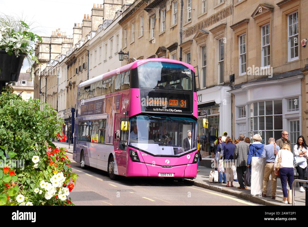 Double decker bus standing at a bus stop, picking up passengers, Bath, Avon, Somerset, England, United Kingdom Stock Photo
