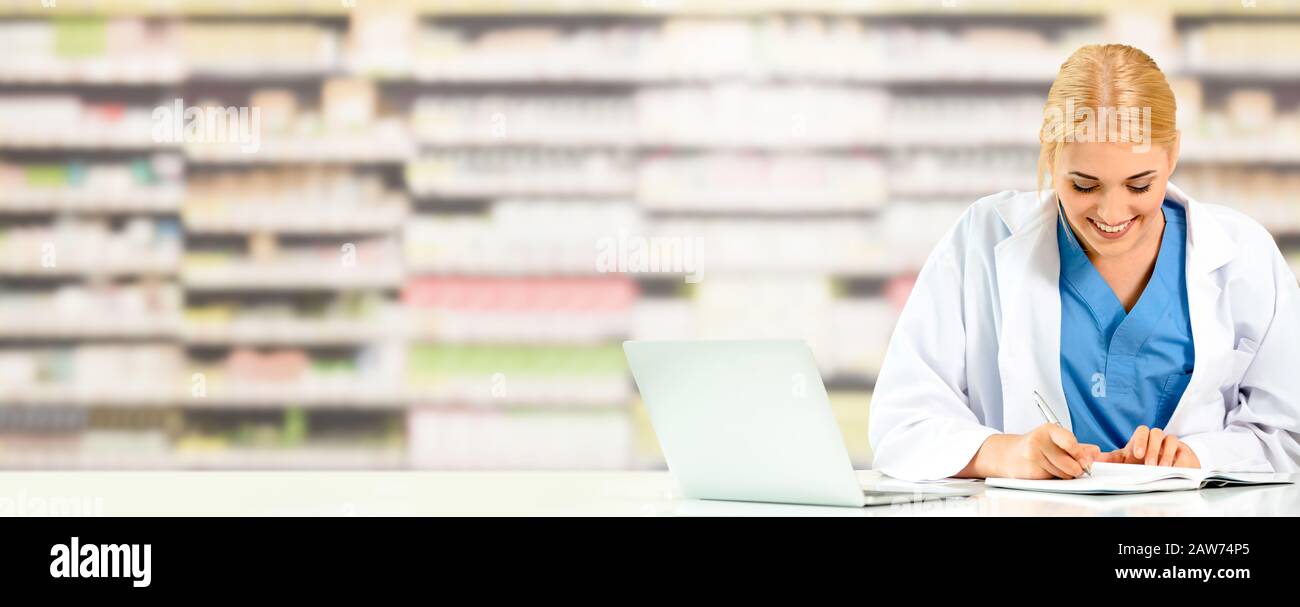 Pharmacist or doctor using laptop computer at the pharmacy room