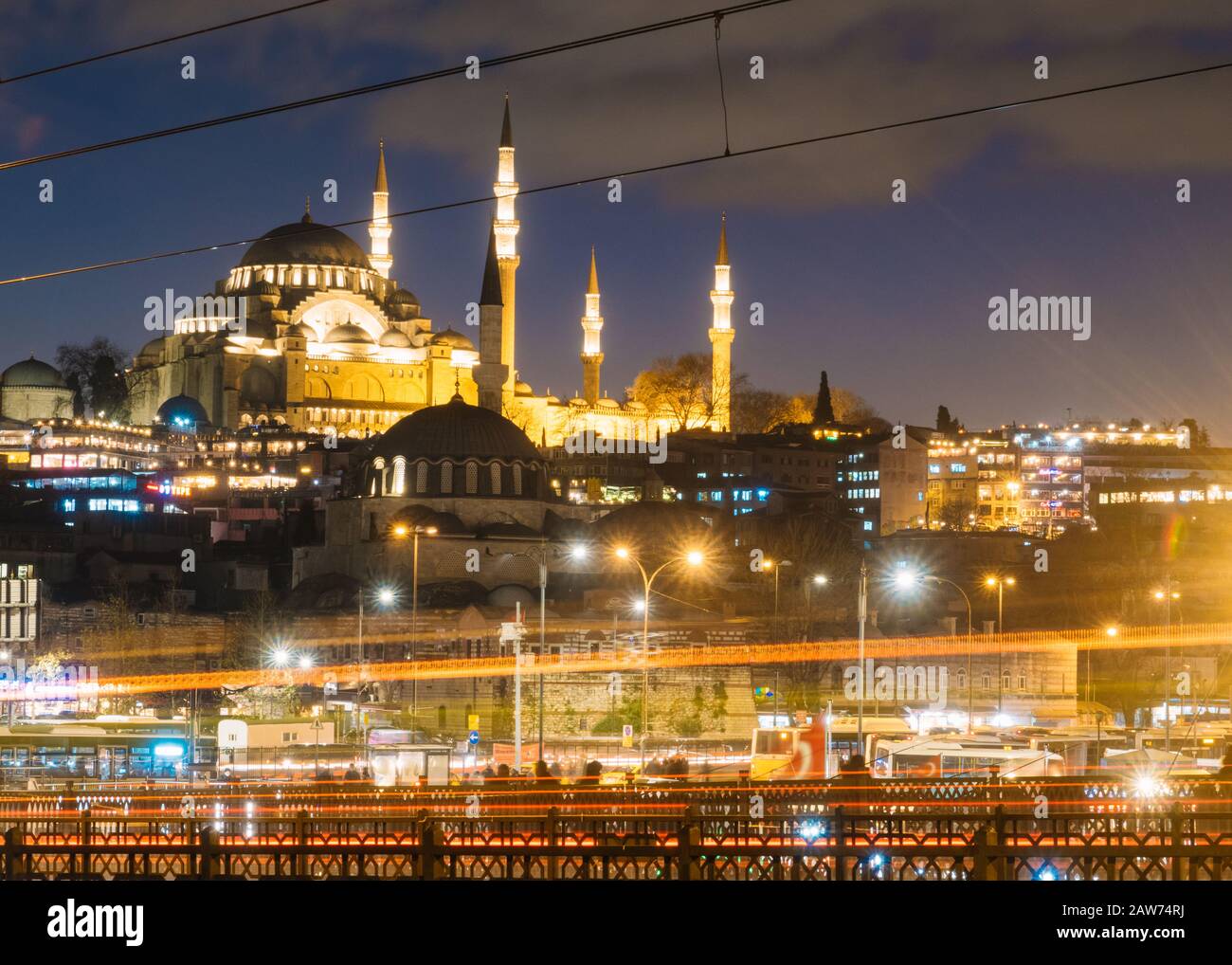 Istanbul, Turkey - Jan 15, 2020: Suleymaniye Mosque with Galata Bridge at night, Istanbul, Turkey. Stock Photo