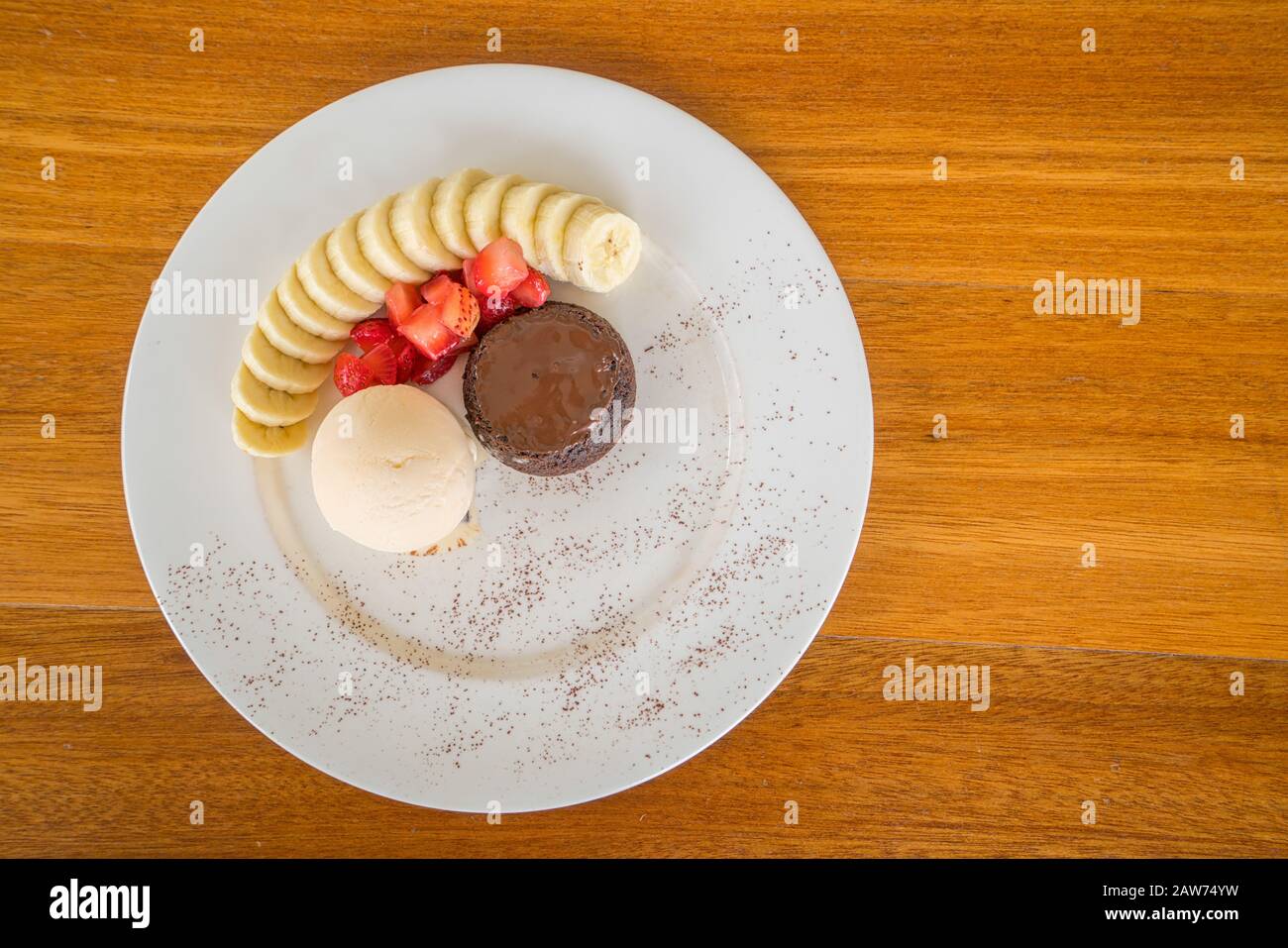 Chocolate lava cake with vanilla icecream, strawberry and banana topping Stock Photo Alamy