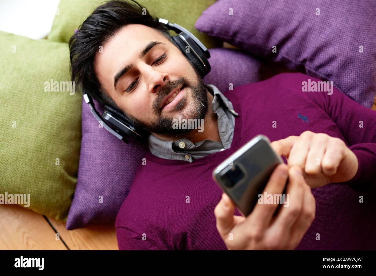 Man listing to music wearing headphones Stock Photo