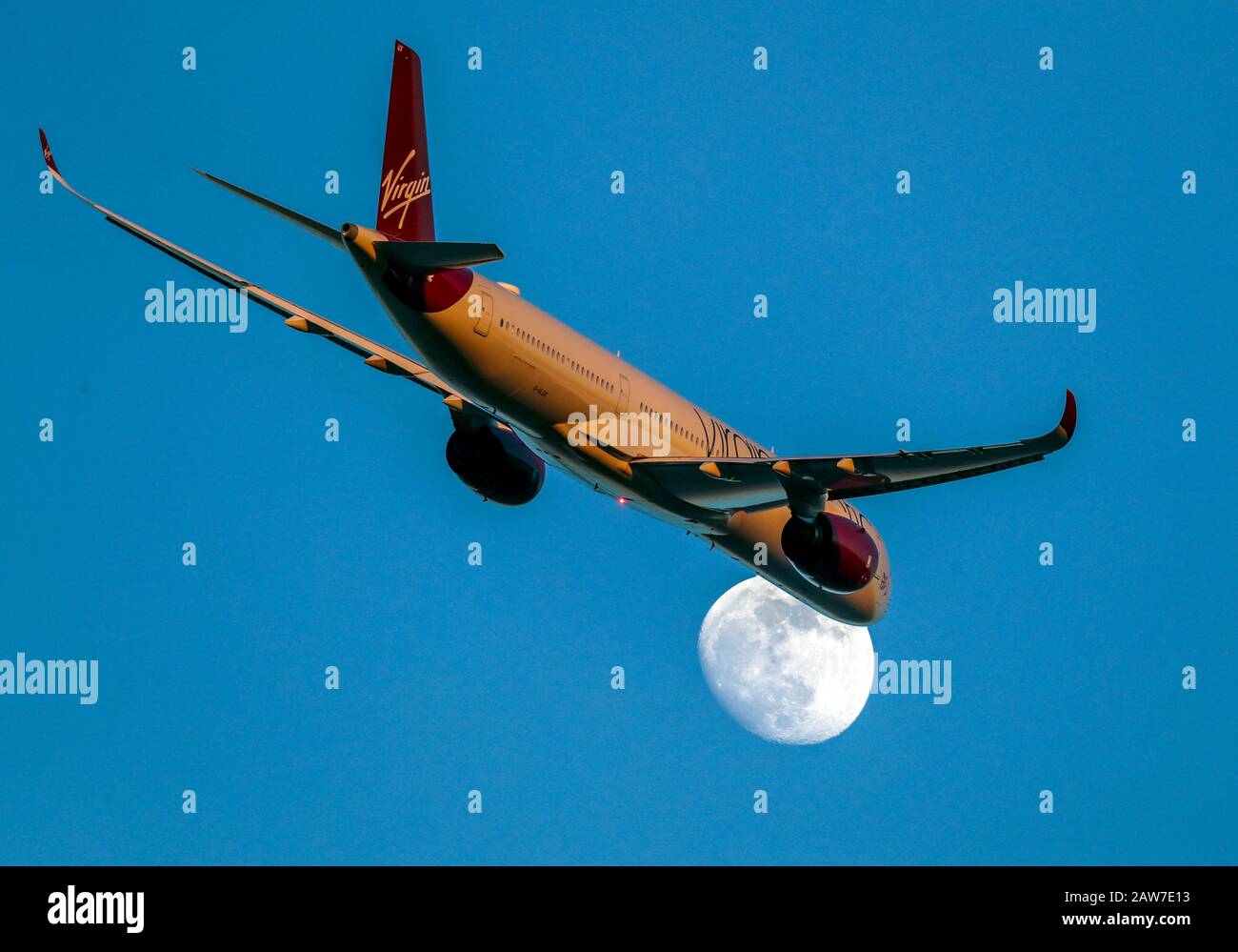 A Virgin Atlantic Airbus A350-1041 with registration G-VLUX passes the moon as it takes off from Heathrow Airport. PA Photo. Picture date: Thursday February 6, 2020. Photo credit should read: Steve Parsons/PA Wire Stock Photo