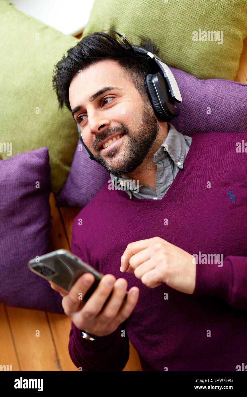 Man listing to music wearing headphones Stock Photo
