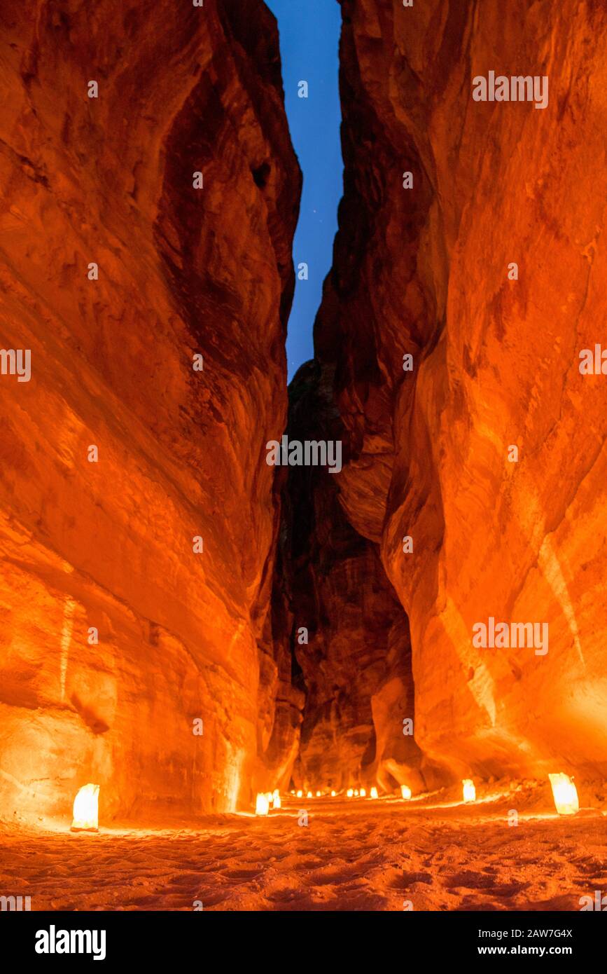 The Siq canyon illuminated by candles at night. Petra, Jordan Stock Photo