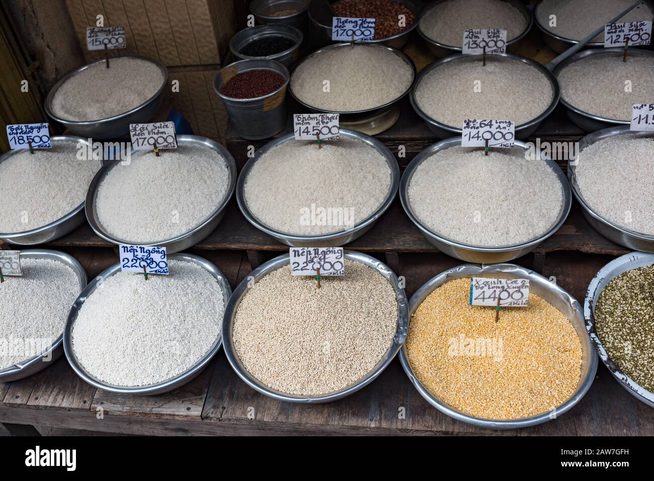 Different types of rice in bowls for sale on farmers market in Vietnam. Street food stall
