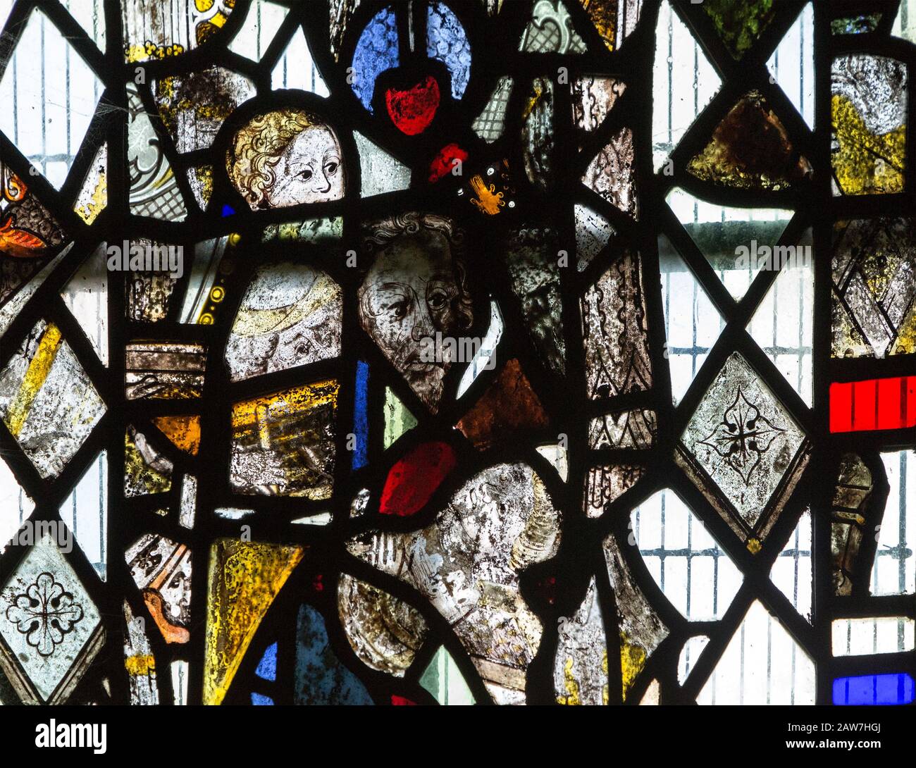 Fragments of medieval stained glass including faces of saints used to