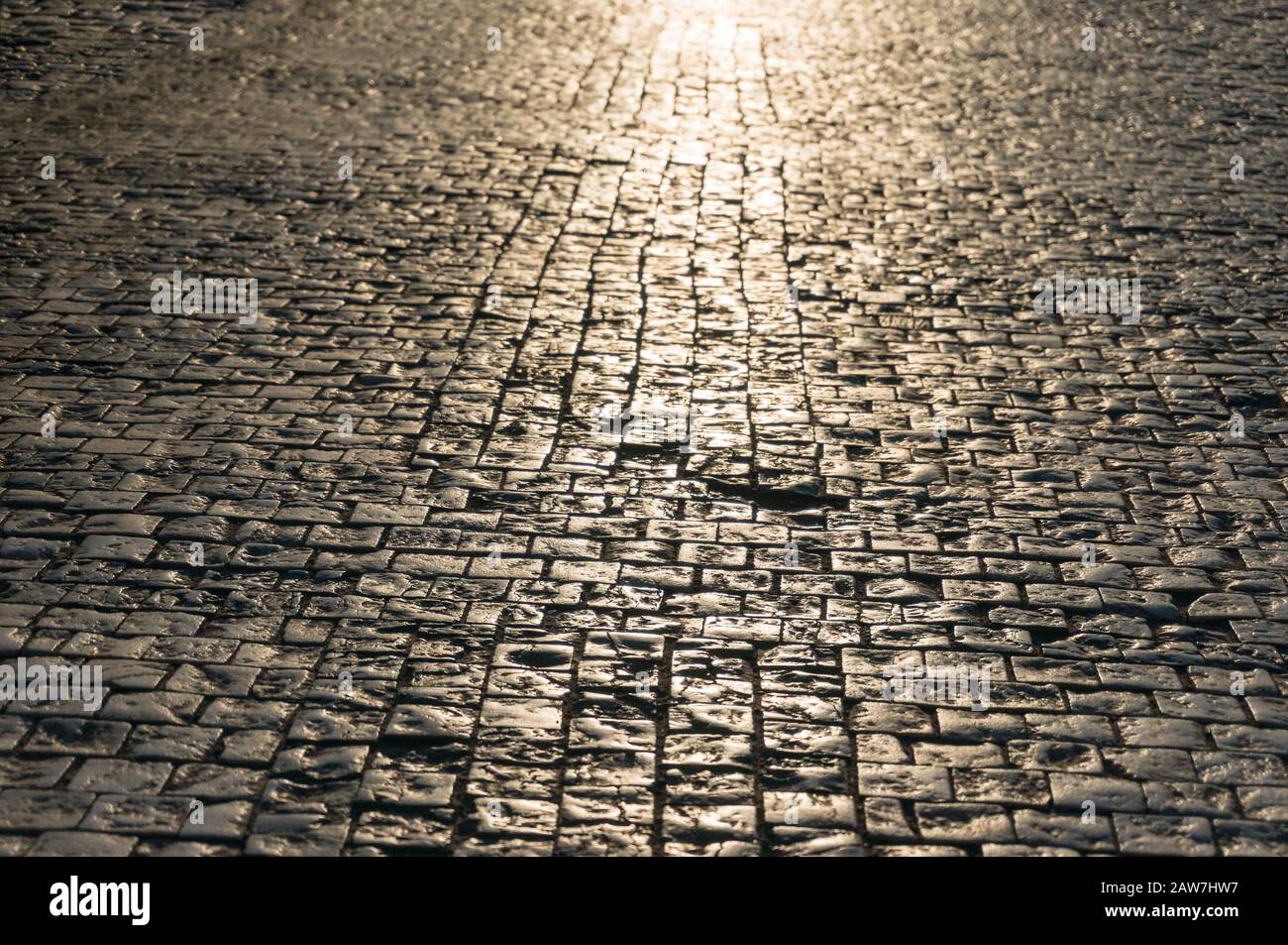 Abstract texture, background of sunlit stone road cobbles Stock Photo