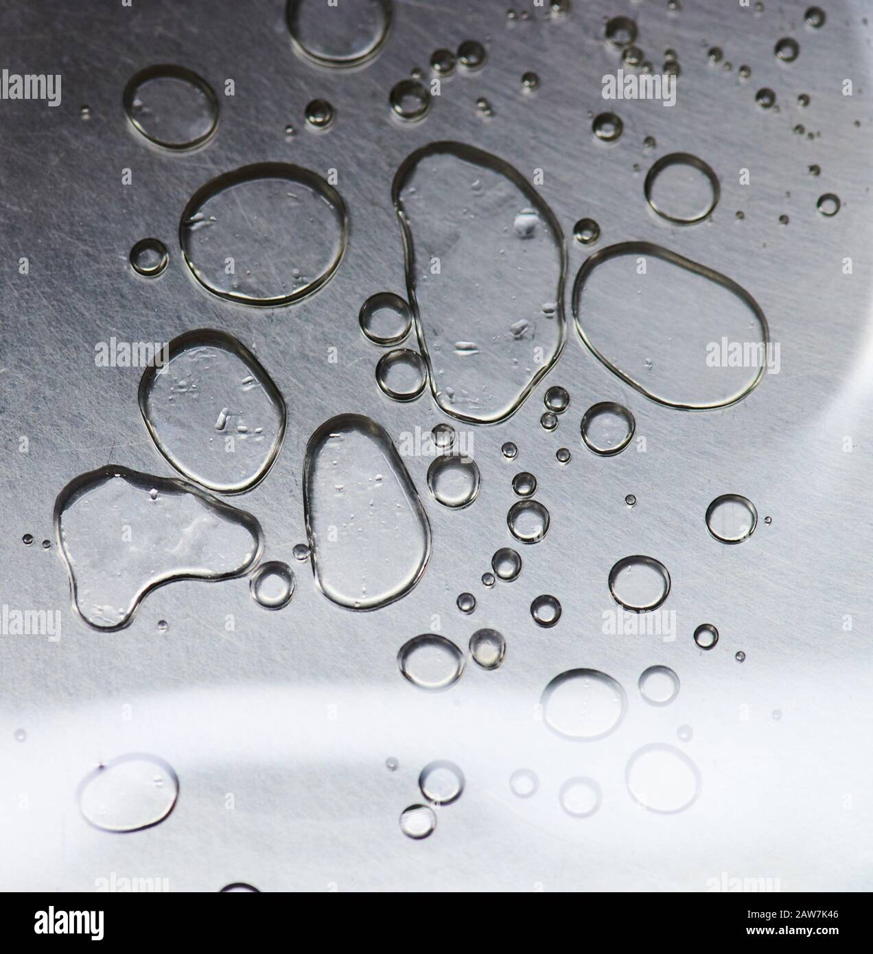 Clean shiny metal surface with water drops macro close up view Stock Photo