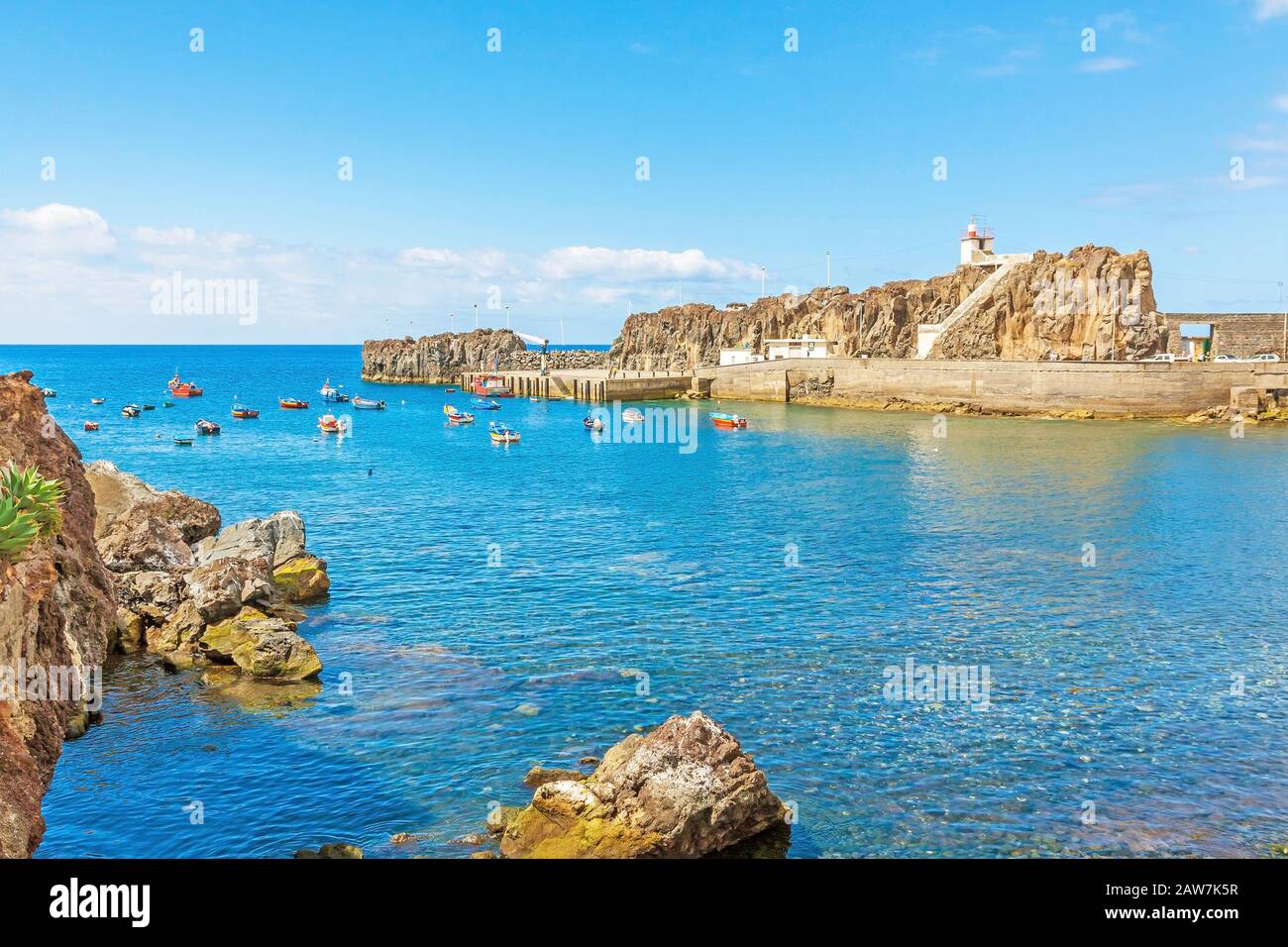 Port of Camara de Lobos, Madeira with fishing boats. The village is typical for its cat shark drying under the sun. Stock Photo