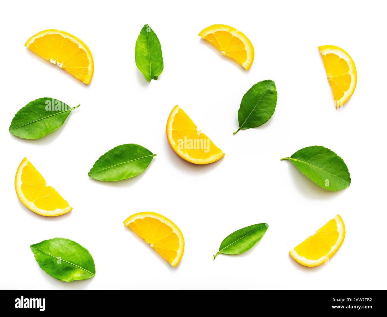 composition of orange slices fruits with green leaves isolated on white background. top view. oranges tropical fruit for background, studio shot Stock Photo