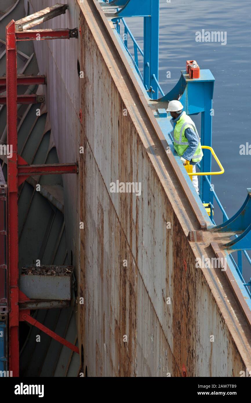 Dock worker inspecting loading of cargo Stock Photo Alamy