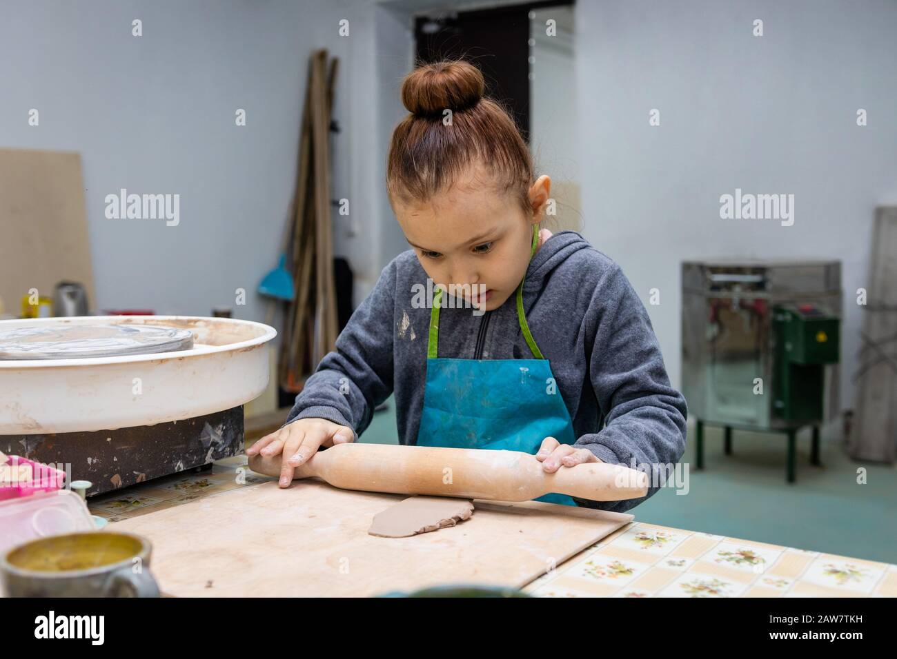 Ceramic Workshop. Clay rolling pin. Work table. Stock Photo by  solerfotostock