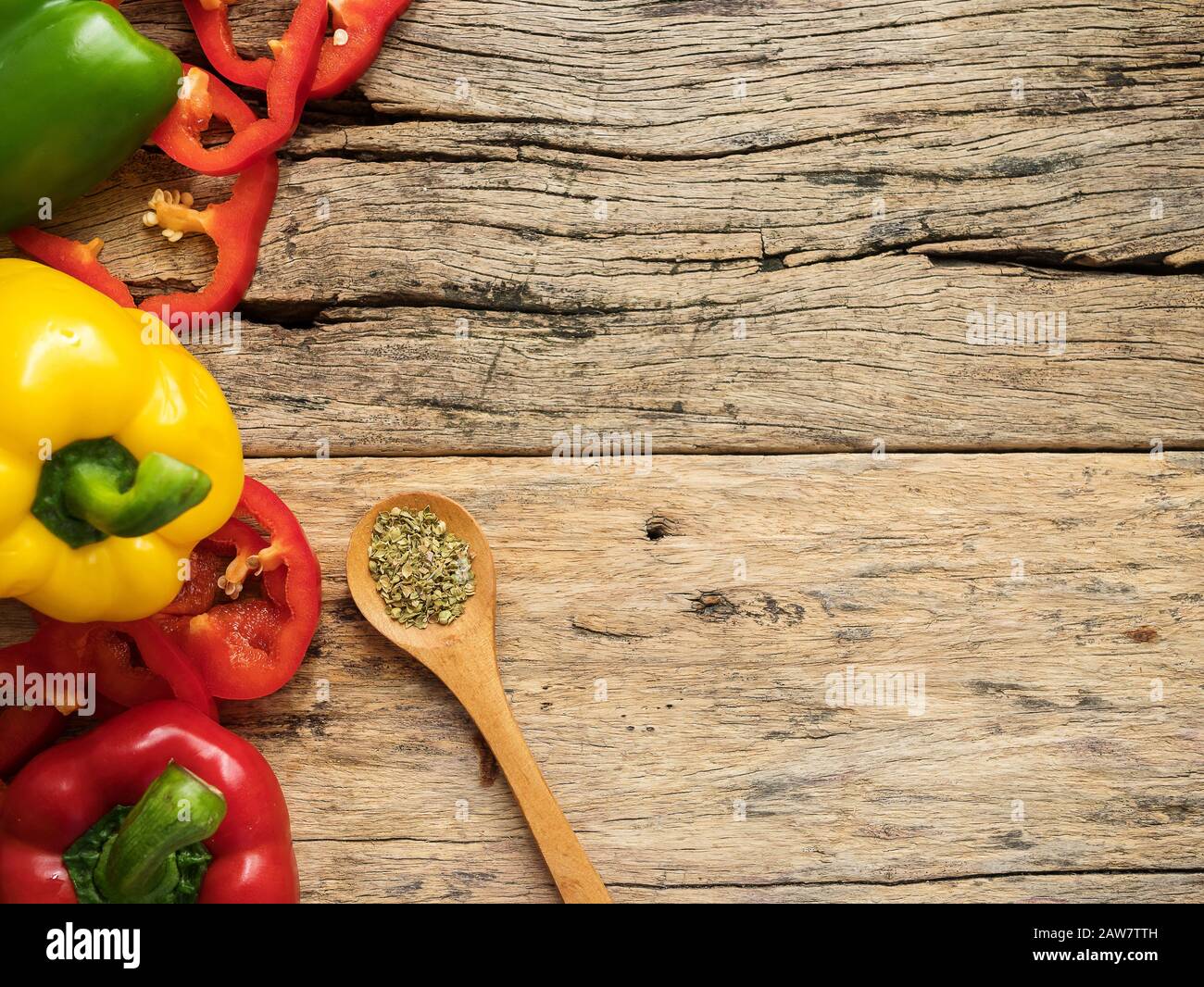 flat lay of blank wooden background space and utensils with herbs , colorful bell pepper and rice plant. top view with copy space. food menu and cooki Stock Photo