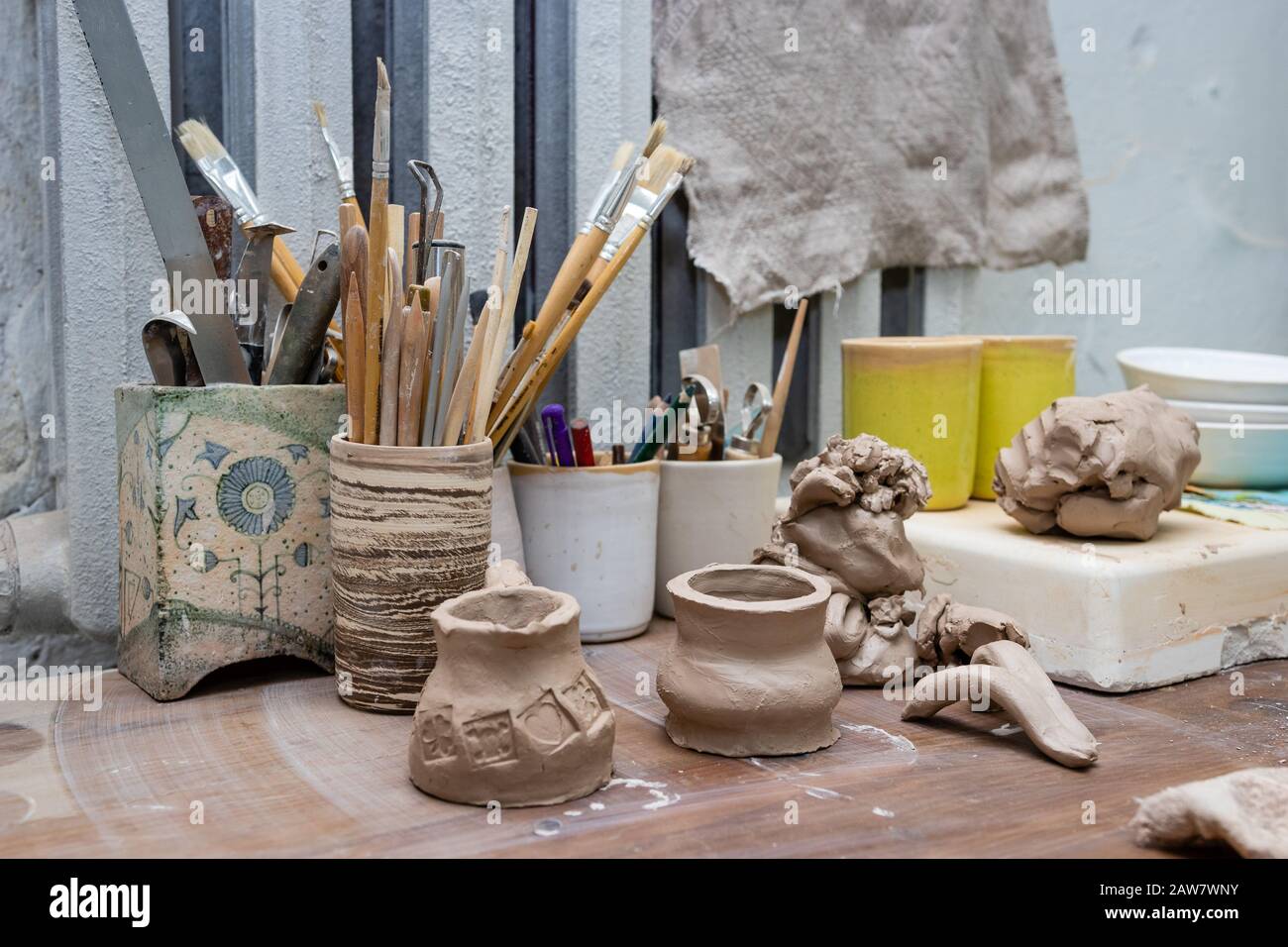 master class in a pottery workshop. still life - modeling tools and unfinished products. Stock Photo