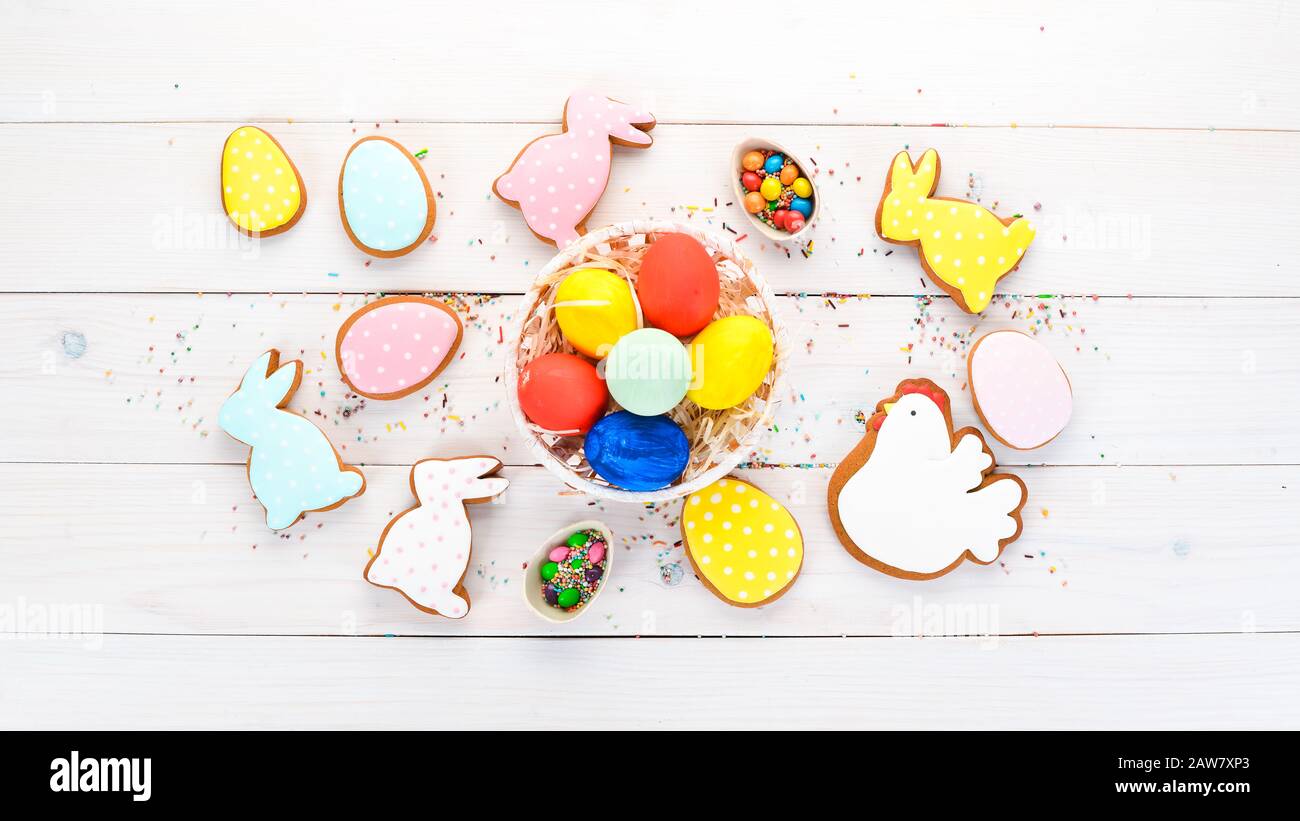 Easter greetings card with colorful gingerbread and sweets. On a white ...