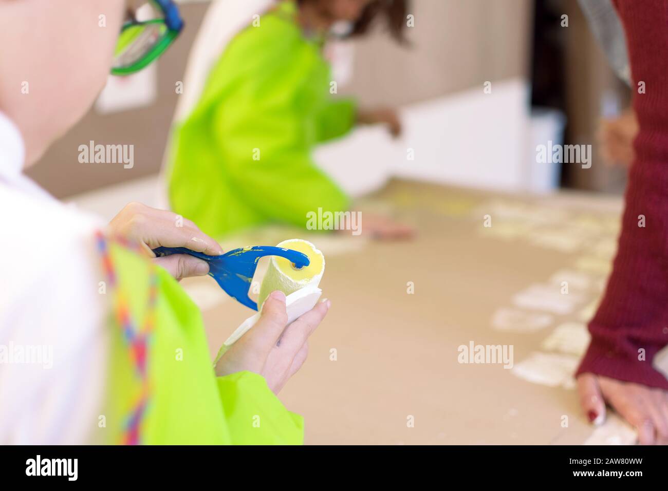 Close-up of a children in art therapy class drawing, painting and practicing engraving art. Child education in primary school at art class in Spain Stock Photo