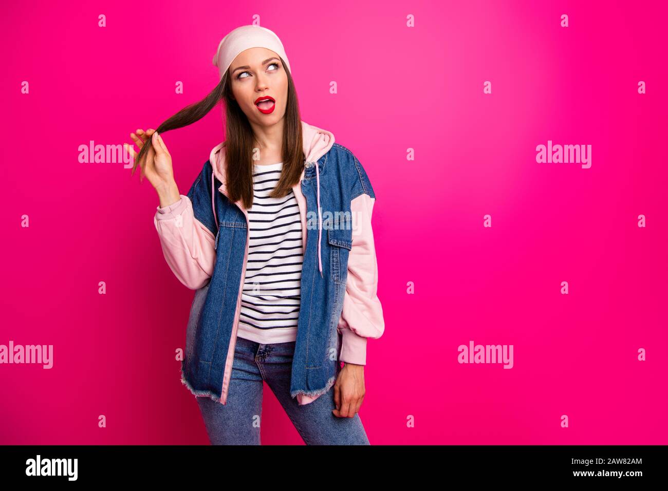 Portrait of her she nice attractive lovely girlish childish cheerful cheery girl wearing street style touching hair hairstyle isolated over bright Stock Photo