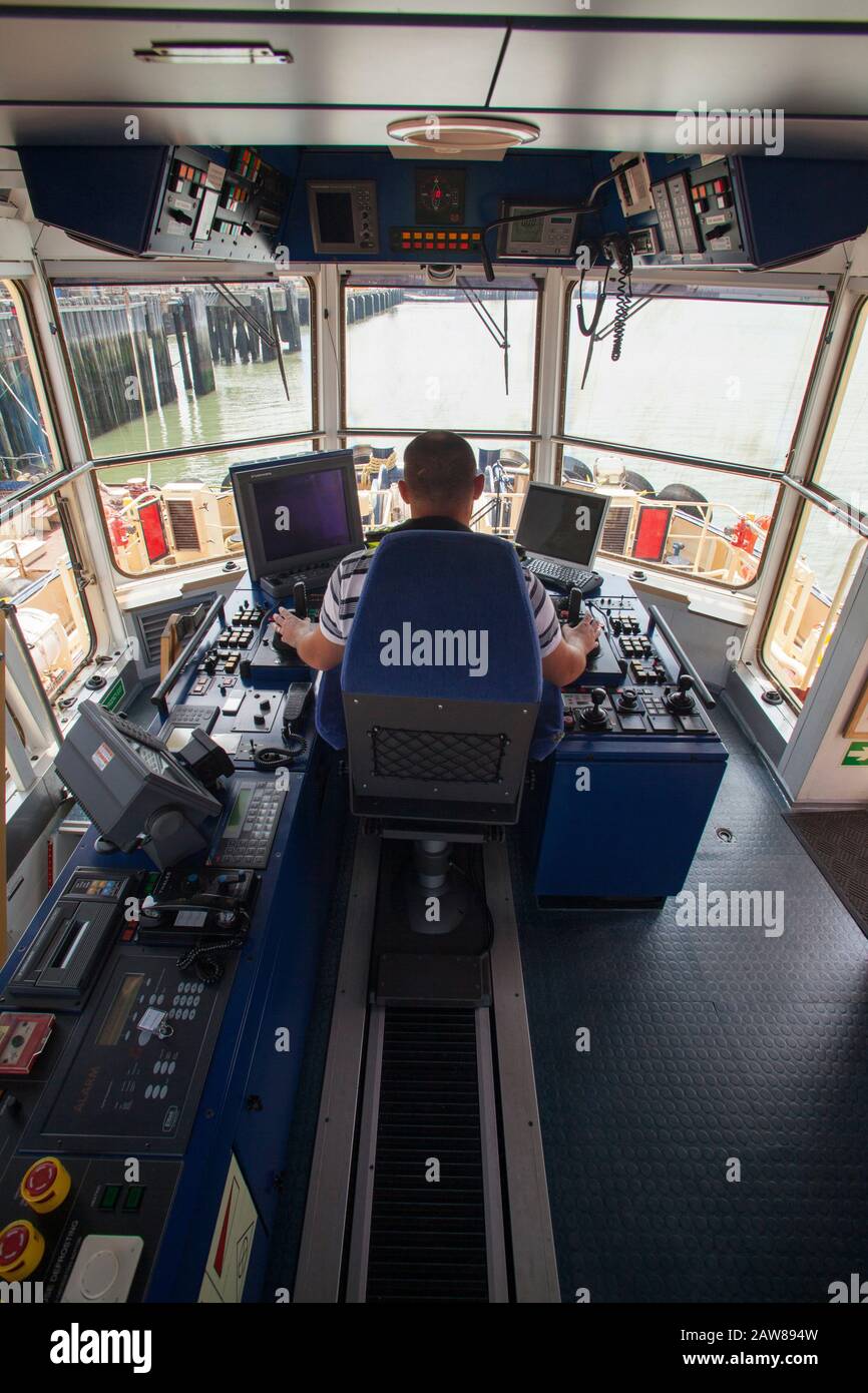 Tug boat captain cockpit tugboat operator driver pilot cab Stock Photo