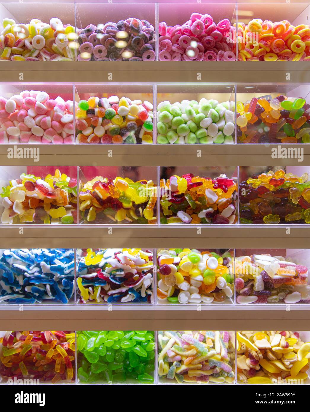 Many colorful sweets on display for pick and mix in a candy shop Stock Photo
