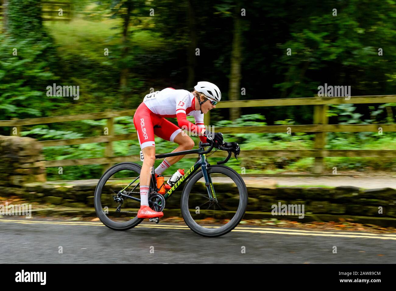 Polish junior male road racing cyclist, riding bike at speed on country lane, competing in cycle race - UCI World Championships, North Yorkshire,UK. Stock Photo
