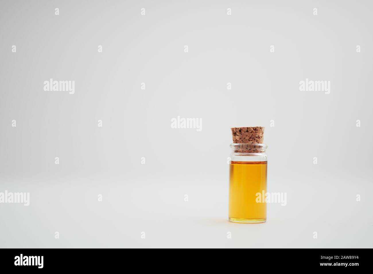 A sample of walnut oil in a glass bottle with a cork Stock Photo