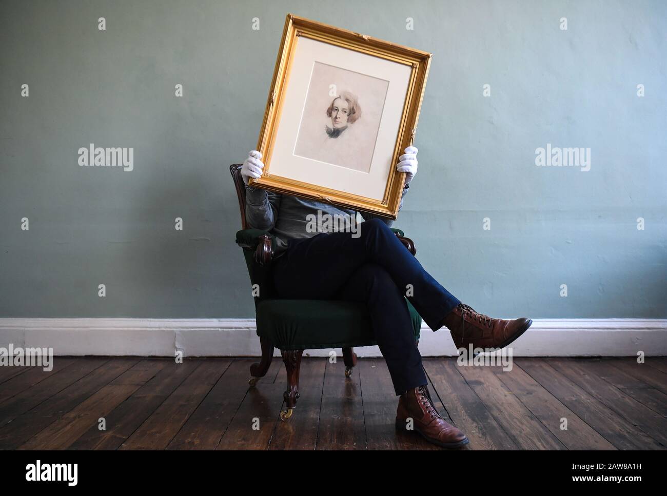 A man holds an unfinished portrait of Charles Dickens by Samuel Laurence, 1837, during a photocall of a new collection of Dickens material at the Charles Dickens Museum in Holborn, central London. Stock Photo