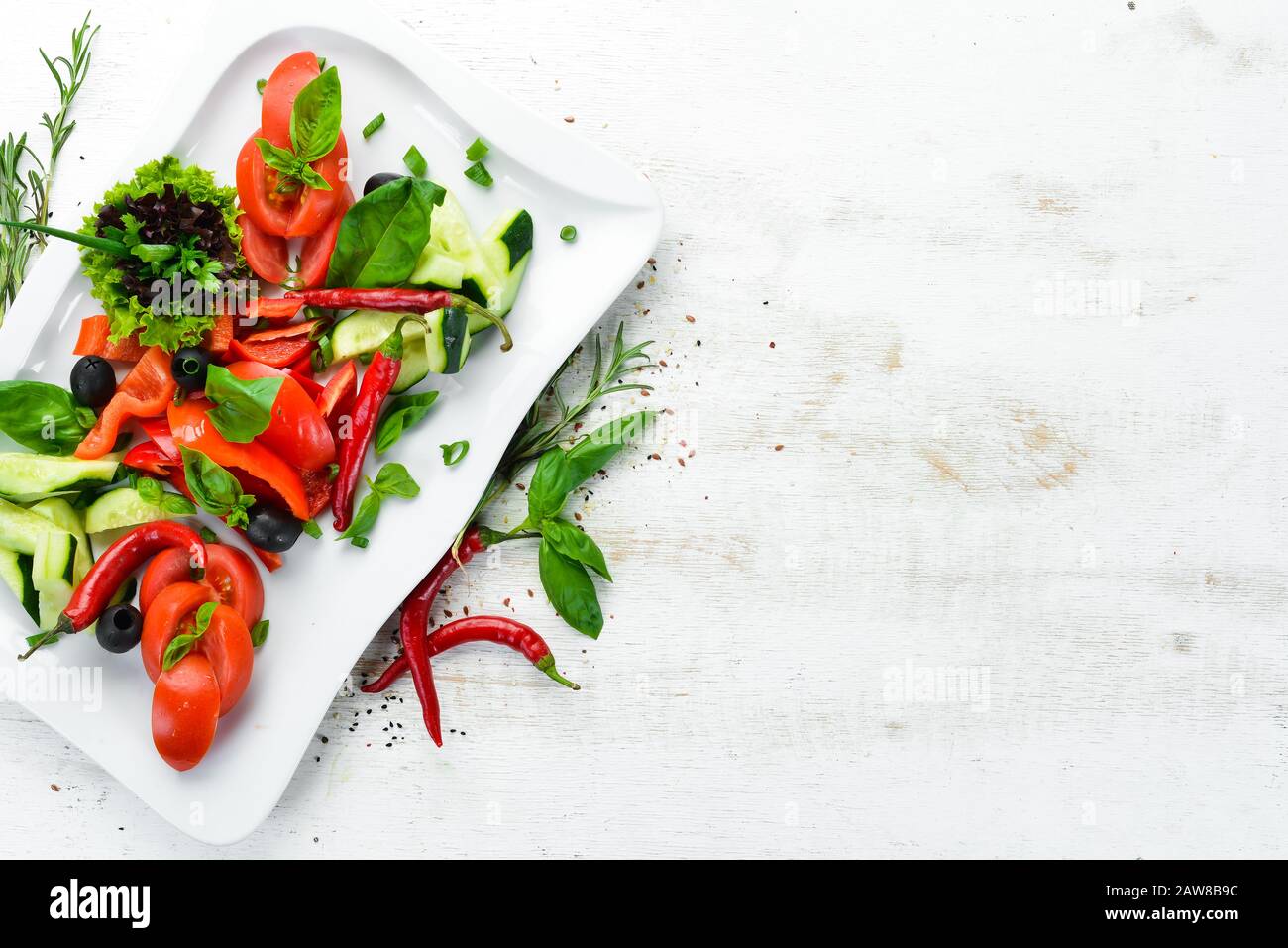 Fresh vegetables on a plate. Restaurant dishes. Top view. Free space